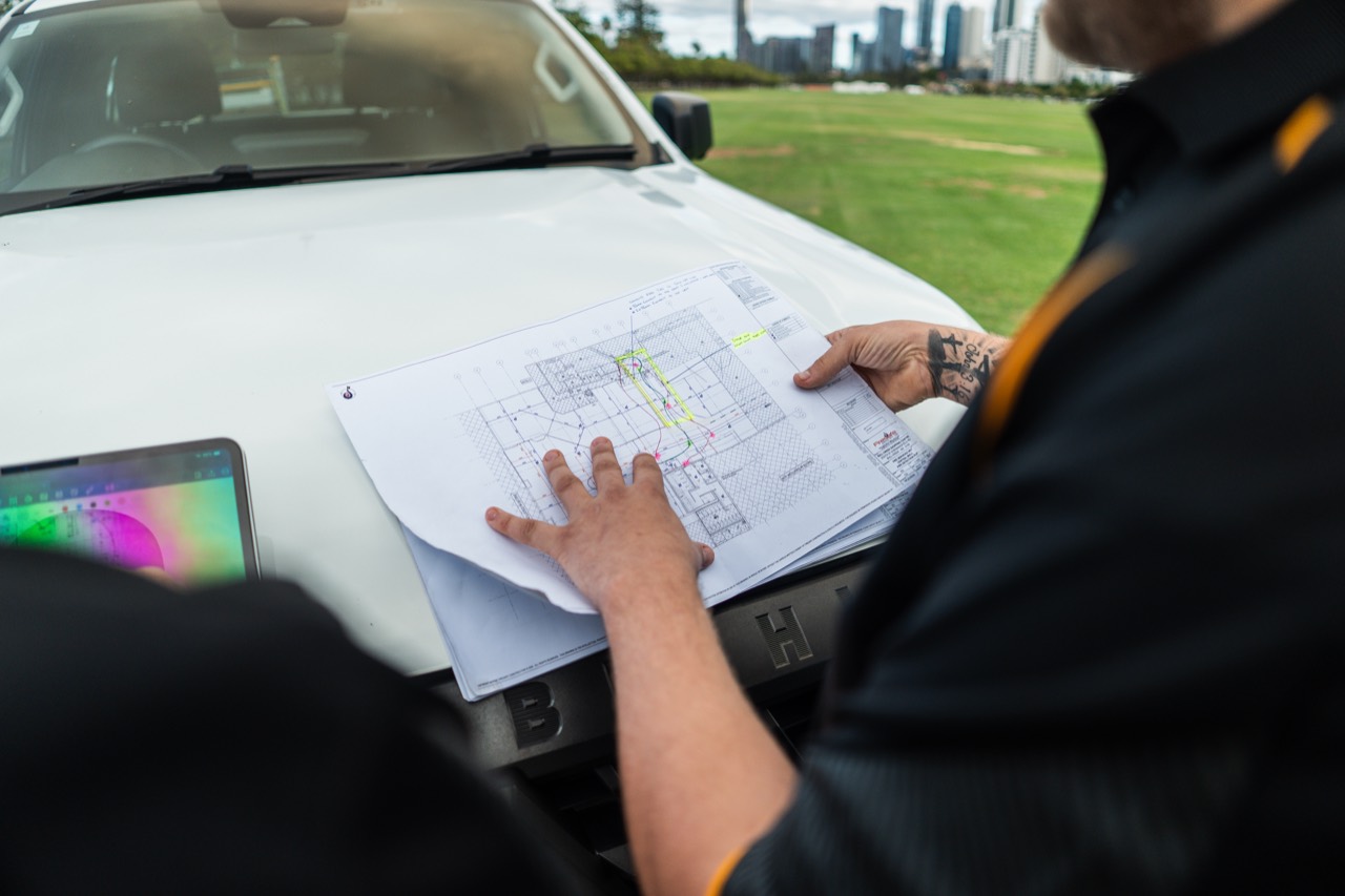behind the scenes — reviewing electrical plans on the ute bonnet